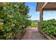 Lush landscaped path leading to a covered porch with stone features and a view of the surrounding landscape at 9 Amaranth Dr, Littleton, CO 80127