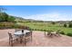 Enjoy outdoor dining on the stone patio with views of the open fields and mountains at 9 Amaranth Dr, Littleton, CO 80127