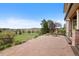 Serene backyard with a stone patio, lush lawn, and picturesque mountain views at 9 Amaranth Dr, Littleton, CO 80127