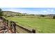 Expansive green space beyond the property's fence offers scenic views of rolling hills at 9 Amaranth Dr, Littleton, CO 80127