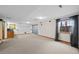 Spacious finished basement with carpeted floors, wet bar, and a large window at 9 Amaranth Dr, Littleton, CO 80127