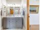 Elegant bathroom features double sinks, granite counters and modern lighting at 9 Amaranth Dr, Littleton, CO 80127