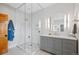 Modern bathroom featuring a glass-enclosed shower, gray vanity with double sinks, and stylish lighting at 9 Amaranth Dr, Littleton, CO 80127
