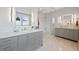 Bright bathroom with double vanity, quartz countertop, glass shower and neutral color palette at 9 Amaranth Dr, Littleton, CO 80127