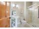 A well-lit bathroom features a pedestal sink, toilet, and glass-enclosed shower at 9 Amaranth Dr, Littleton, CO 80127