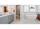 A bathroom featuring double sinks, a soaking tub and modern fixtures at 9 Amaranth Dr, Littleton, CO 80127