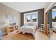 Cozy bedroom featuring large window, hardwood floors and a mirrored closet at 9 Amaranth Dr, Littleton, CO 80127