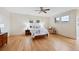 Spacious bedroom with hardwood floors, ceiling fan, large windows and neutral color palette at 9 Amaranth Dr, Littleton, CO 80127