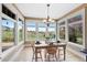 Bright dining room features large windows with scenic views, chandelier, and wood table and chairs at 9 Amaranth Dr, Littleton, CO 80127