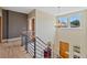 Bright entryway with hardwood floors, modern railing and chandelier and a view to the outdoors at 9 Amaranth Dr, Littleton, CO 80127