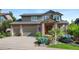 Attractive two-story home featuring a brick-accented facade, attached two-car garage, and professionally landscaped front yard at 9 Amaranth Dr, Littleton, CO 80127