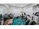 Basement workout area filled with exercise machines and mirrored wall at 9 Amaranth Dr, Littleton, CO 80127