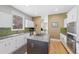 Bright kitchen featuring granite counters, stainless appliances, and an island with a cooktop at 9 Amaranth Dr, Littleton, CO 80127