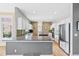 Modern kitchen with stainless steel appliances, granite countertops, white cabinets, and hardwood floors at 9 Amaranth Dr, Littleton, CO 80127