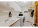 Practical laundry room equipped with a sink, washer, dryer, and ample storage space at 9 Amaranth Dr, Littleton, CO 80127
