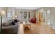 Cozy living room featuring hardwood floors, neutral colors, a large window, and comfortable seating arrangements at 9 Amaranth Dr, Littleton, CO 80127