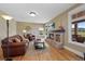 Warm living room with leather furniture, brick fireplace, and lots of natural light at 9 Amaranth Dr, Littleton, CO 80127