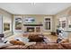 Comfortable living room with hardwood floors, brick fireplace, and lots of natural light and a TV at 9 Amaranth Dr, Littleton, CO 80127
