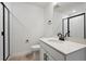 Bathroom featuring a modern vanity with a white countertop, black fixtures, and glass shower door at 24768 E 40Th Ave, Aurora, CO 80019