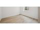 Cozy bedroom featuring wood floors, a large window, and neutral decor at 24768 E 40Th Ave, Aurora, CO 80019