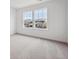 Bright bedroom featuring neutral carpet, white walls, and two windows for ample natural light at 24768 E 40Th Ave, Aurora, CO 80019