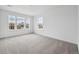 Bright bedroom featuring neutral carpet, white walls, and multiple windows for ample natural light at 24768 E 40Th Ave, Aurora, CO 80019