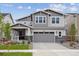 Charming two-story home with gray siding, stone accents, and a well-manicured front yard at 24768 E 40Th Ave, Aurora, CO 80019