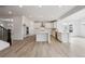 Modern kitchen with white cabinets, stainless steel appliances, and a center island at 24768 E 40Th Ave, Aurora, CO 80019