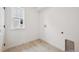 Well-lit laundry room featuring tile flooring, white walls and trim, and a window providing natural light at 24768 E 40Th Ave, Aurora, CO 80019