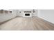 Open-concept living room with fireplace, wood flooring, and lots of natural light at 24768 E 40Th Ave, Aurora, CO 80019