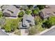 Overhead view of a home with a well-maintained roof, surrounded by mature trees and green yards at 4875 E 117Th Dr, Thornton, CO 80233