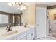 Bathroom featuring a double sink vanity, bathtub and glass enclosed shower at 4875 E 117Th Dr, Thornton, CO 80233
