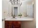 Powder room with wood vanity and modern fixtures at 4875 E 117Th Dr, Thornton, CO 80233