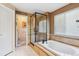 Bright bathroom featuring a soaking tub, glass shower, and separate toilet room at 4875 E 117Th Dr, Thornton, CO 80233