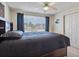 Bedroom featuring a large window, ceiling fan, and spacious closet at 4875 E 117Th Dr, Thornton, CO 80233
