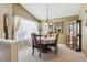 Cozy dining area with a table, chairs, hutch, and large windows with curtains at 4875 E 117Th Dr, Thornton, CO 80233
