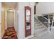 Inviting foyer with hardwood floors, a decorative mirror, and carpeted stairs leading upstairs at 4875 E 117Th Dr, Thornton, CO 80233