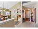 Open-concept foyer featuring hardwood flooring, a coat rack, and a view to the kitchen and dining area at 4875 E 117Th Dr, Thornton, CO 80233