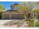Exterior showcasing a two-car garage, well-maintained lawn, and beautiful landscaping at 4875 E 117Th Dr, Thornton, CO 80233