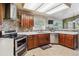 Well-equipped kitchen with stainless steel appliances, and mosaic tile backsplash at 4875 E 117Th Dr, Thornton, CO 80233