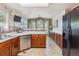Bright kitchen with modern appliances, a breakfast bar, and ample counter space at 4875 E 117Th Dr, Thornton, CO 80233