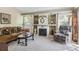 Cozy living room with a decorative fireplace, mantle, and natural light from the windows at 4875 E 117Th Dr, Thornton, CO 80233