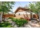 Backyard includes a garden bed, grassy area, stone pathway, and wooden fence, creating a tranquil outdoor space at 315 S Franklin St, Denver, CO 80209