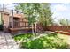 Backyard features a wooden deck, a small grassy area, a stone pathway, and wooden fencing at 315 S Franklin St, Denver, CO 80209