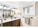 Bright bathroom featuring double vanity, glass enclosed shower, modern fixtures, and neutral tones for a spa-like experience at 315 S Franklin St, Denver, CO 80209