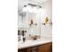 Charming bathroom featuring a stylish vanity with bronze fixtures, and decoratively lit with a modern light fixture at 315 S Franklin St, Denver, CO 80209