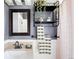 Neat bathroom featuring sleek shelving with towels and toiletries, with soft grey walls and a clean design at 315 S Franklin St, Denver, CO 80209