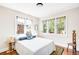 Bright bedroom with three large windows, hardwood floors, and a cozy, comfortable bed setup at 315 S Franklin St, Denver, CO 80209