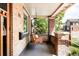 Cozy covered porch with a swing, brick pillars, and views of the neighborhood at 315 S Franklin St, Denver, CO 80209