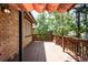 A spacious wooden deck features a wooden railing and overhead shade providing an outdoor living space at 315 S Franklin St, Denver, CO 80209